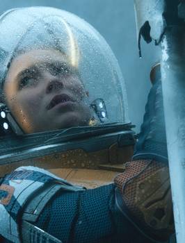 A woman in a retro glass and leather spacesuit climbs a ladder in Lost in Space
